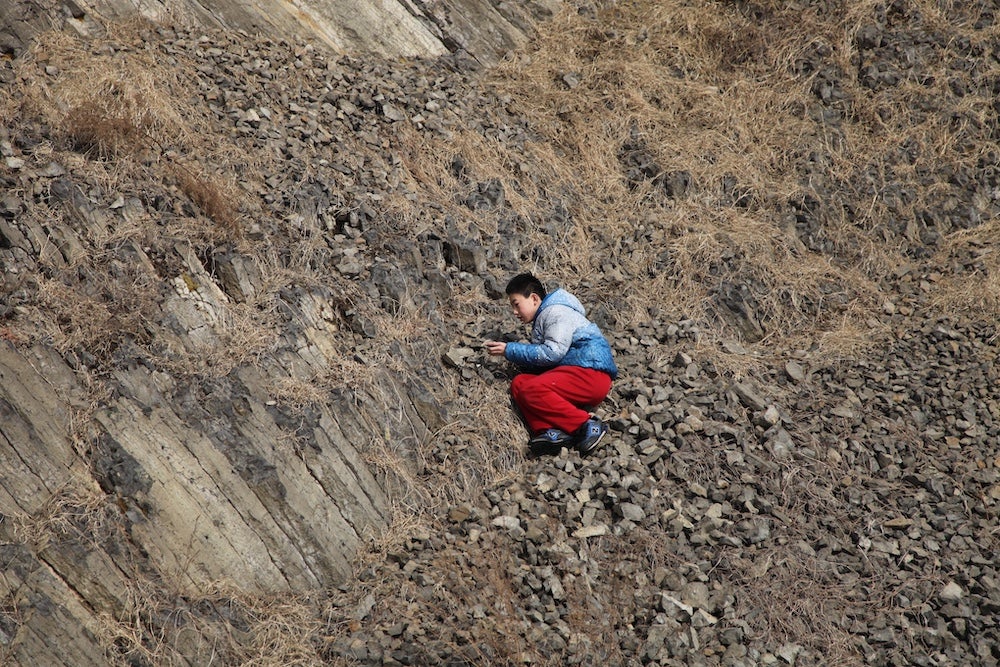Zhang searching for sapphires in basalt in 2011