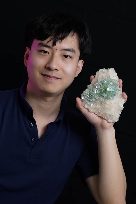 Tom Zhang portrait holding zeolite mineral sample