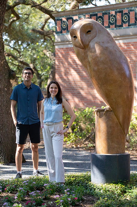 Adnan Dehghani and Noemi Vergopolan stand together next to the Rice Owl