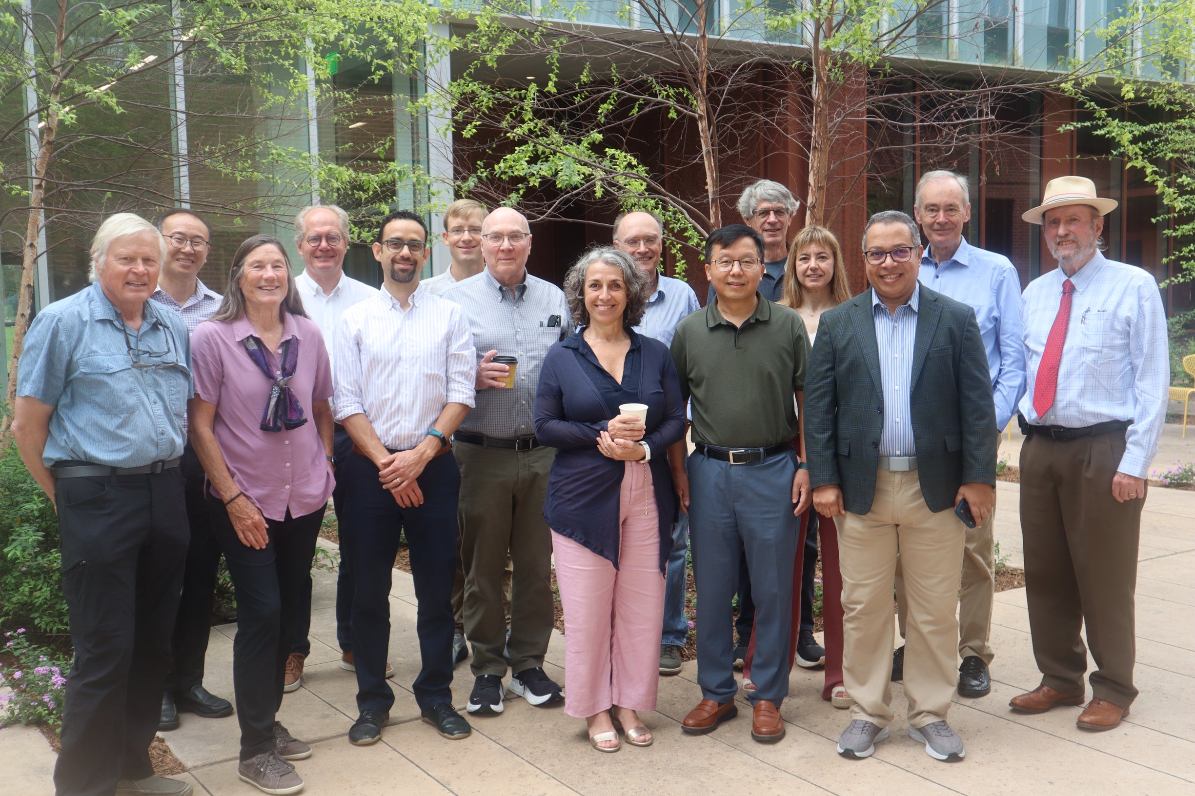 Photo of Alan Levander with former students and colleagues at Kraft Hall courtyard