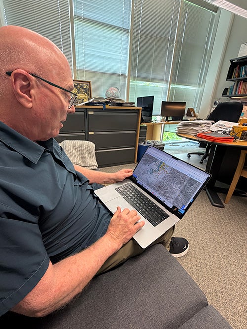 Photo of Alan Levander in his office with laptop 