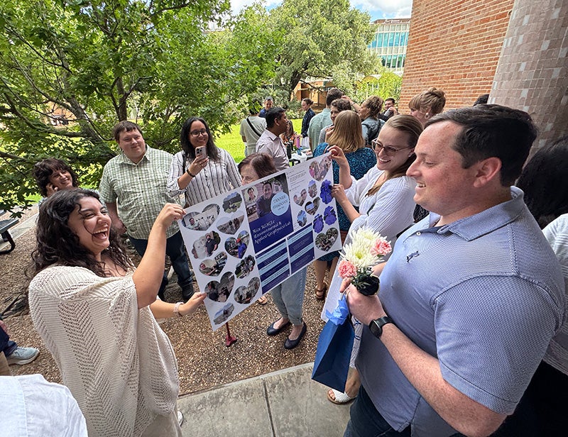 Image of Dr. Tanner Shadoan with going away banner at the EEPS graduation reception