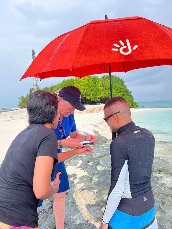 André Droxler (center) with students, Shahba (left) and Ali (right),  on Rasfari Island.  examining beach rocks representing the last 2,000 years of the 55 million year-long evolution of the Maldives Archipelago . Photo Tonti, EPA, Maldives Republic.