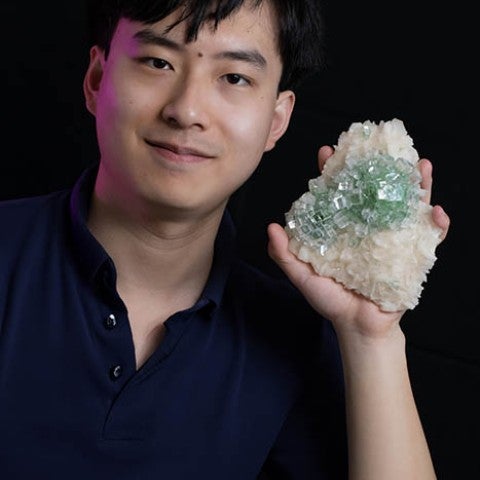 Tom Zhang portrait with apophyllite mineral specimen