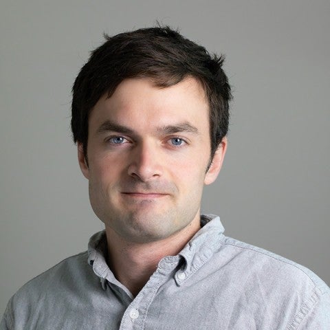 Photo of head and shoulders of Ian McBrearty on a gray background